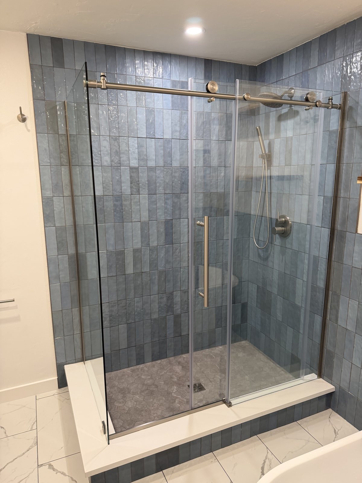 Tile shower with glass enclosure in Carbondale, by Rock Royalty